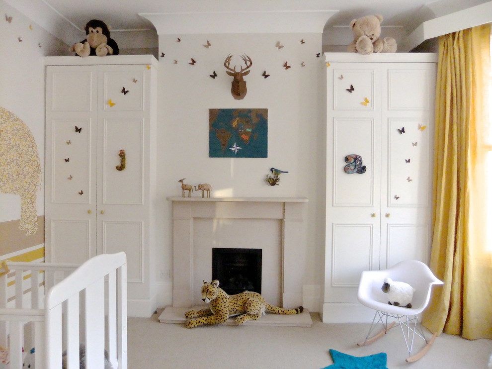 Inspiration for a large eclectic girl carpeted nursery remodel in London