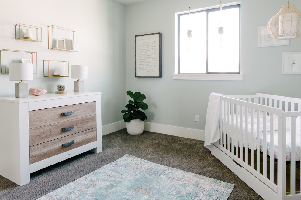 Photo of a medium sized contemporary gender neutral nursery in Salt Lake City with blue walls, carpet and grey floors.