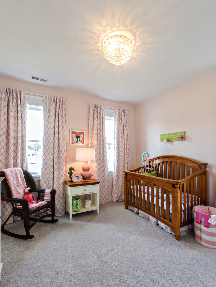 Design ideas for a medium sized country nursery for girls in Other with pink walls and carpet.