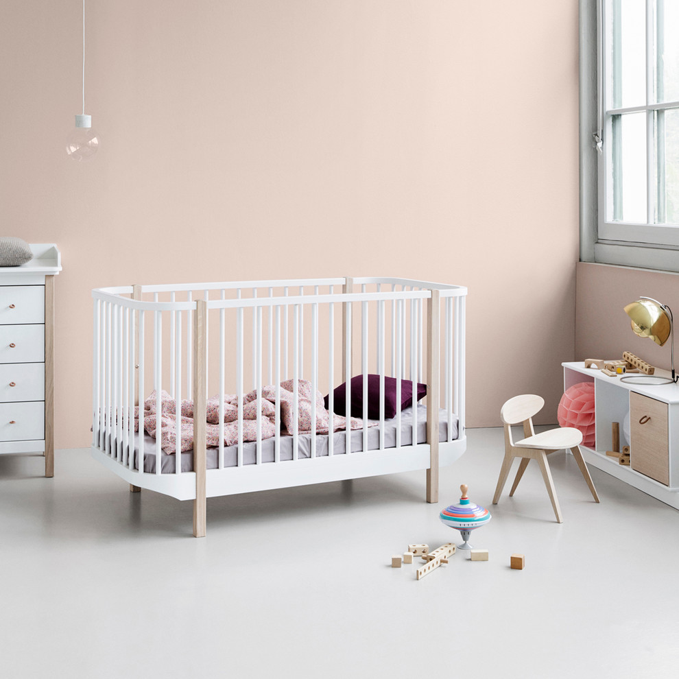 Example of a danish girl nursery design in Dorset with pink walls