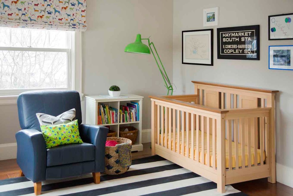 Large classic nursery for boys in Boston with grey walls and medium hardwood flooring.
