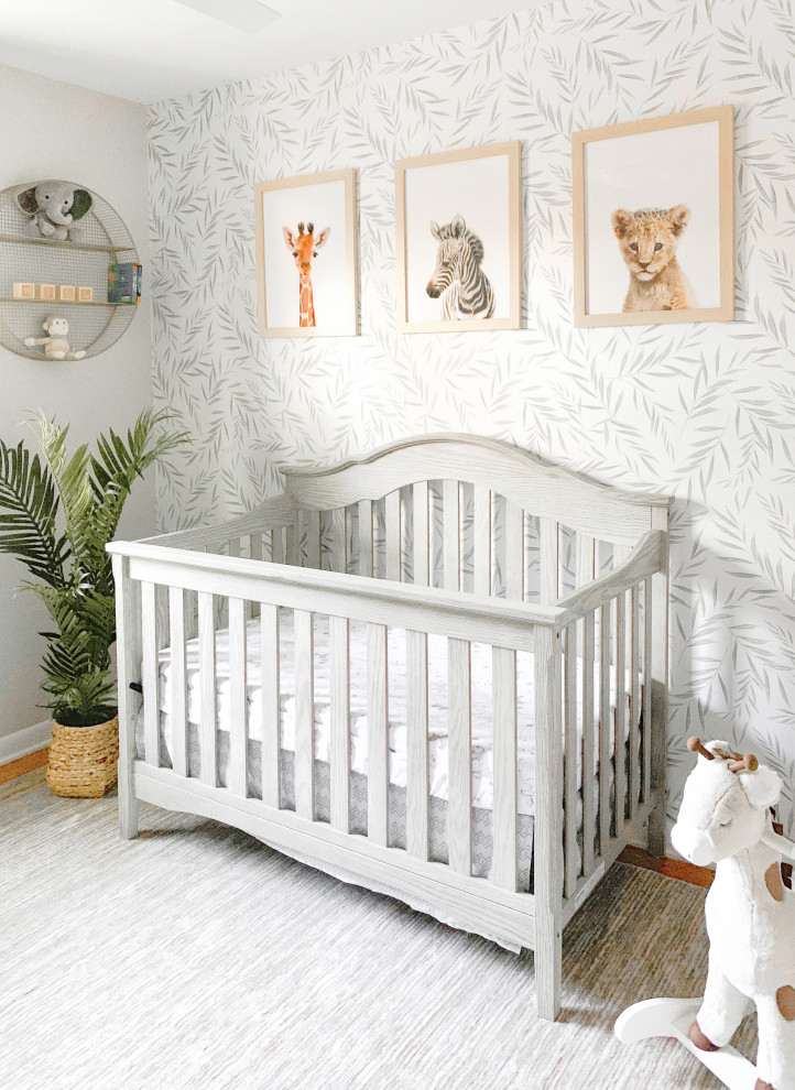 This is an example of a medium sized classic gender neutral nursery with beige walls, medium hardwood flooring and brown floors.