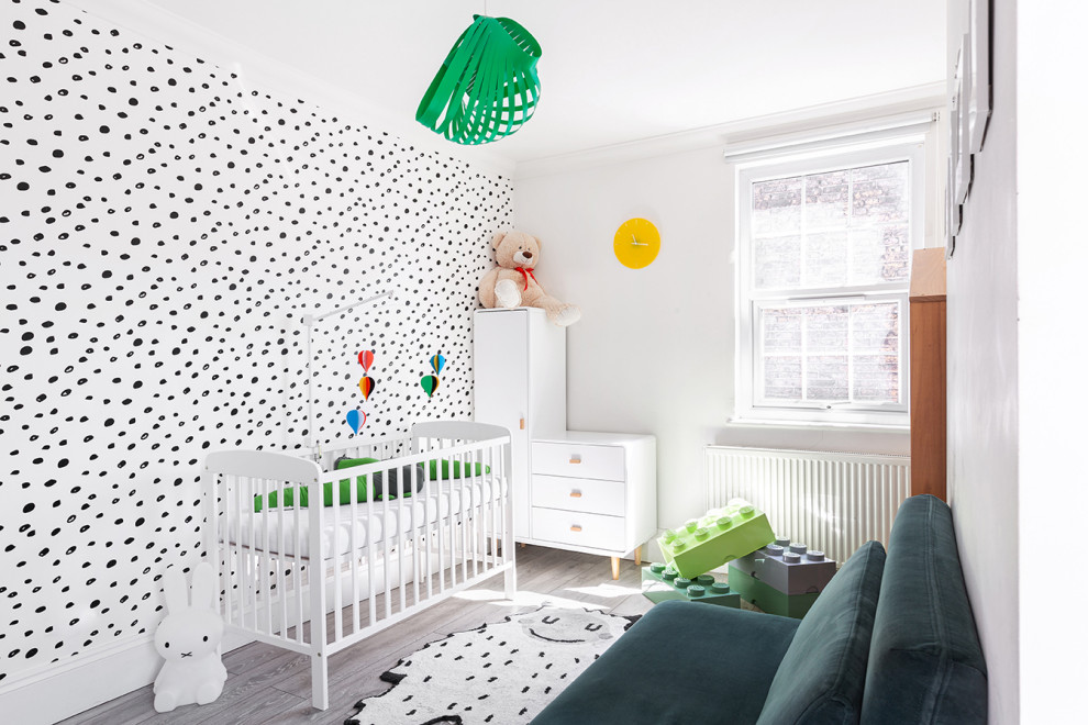 Inspiration for a medium sized scandi gender neutral nursery in London with multi-coloured walls, light hardwood flooring, grey floors and wallpapered walls.