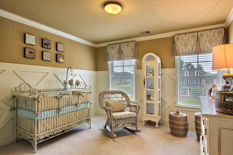 Example of a large classic gender-neutral carpeted nursery design in Atlanta with brown walls
