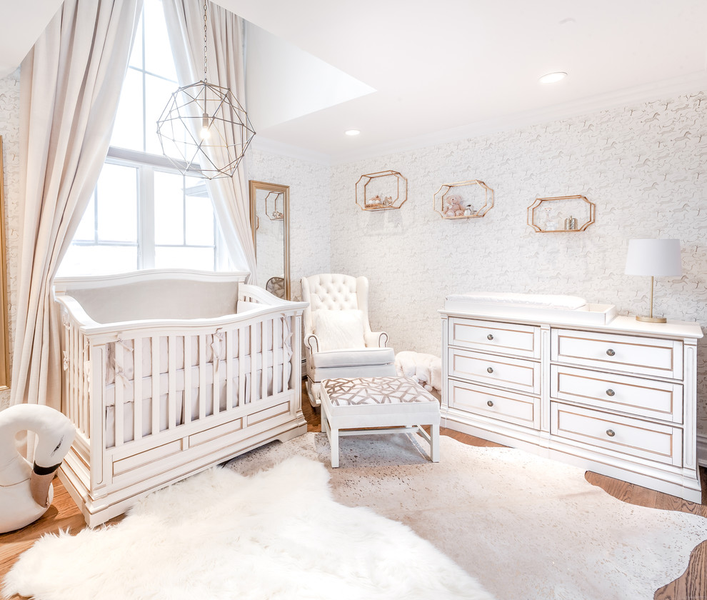 This is an example of a medium sized classic nursery for girls in New York with white walls.