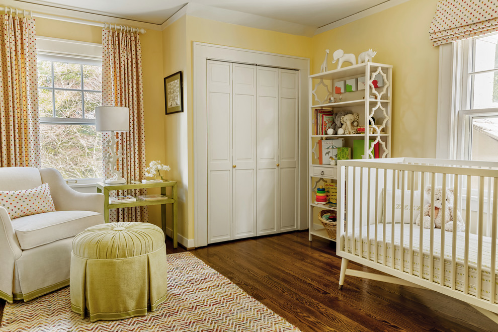 Medium sized classic gender neutral nursery in Portland with yellow walls, dark hardwood flooring and brown floors.