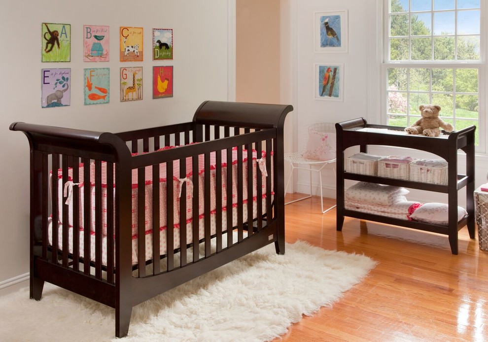 Cette image montre une chambre de bébé neutre traditionnelle de taille moyenne avec un mur blanc.