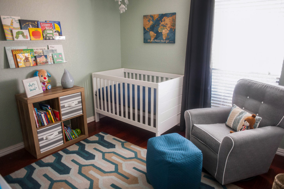 Small modern nursery for boys in Dallas with green walls, dark hardwood flooring and brown floors.