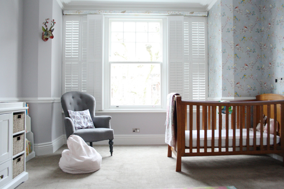 Transitional gender-neutral carpeted and gray floor nursery photo in London with gray walls