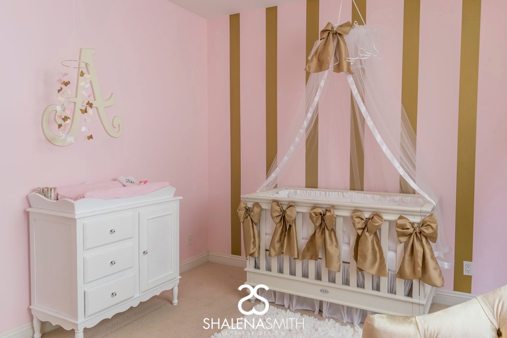 Contemporary nursery for girls in Los Angeles with pink walls.