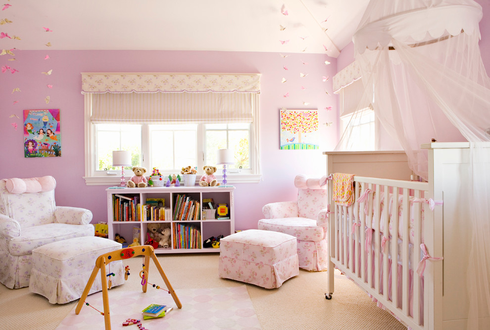 Nursery - large traditional girl carpeted nursery idea in Los Angeles with pink walls