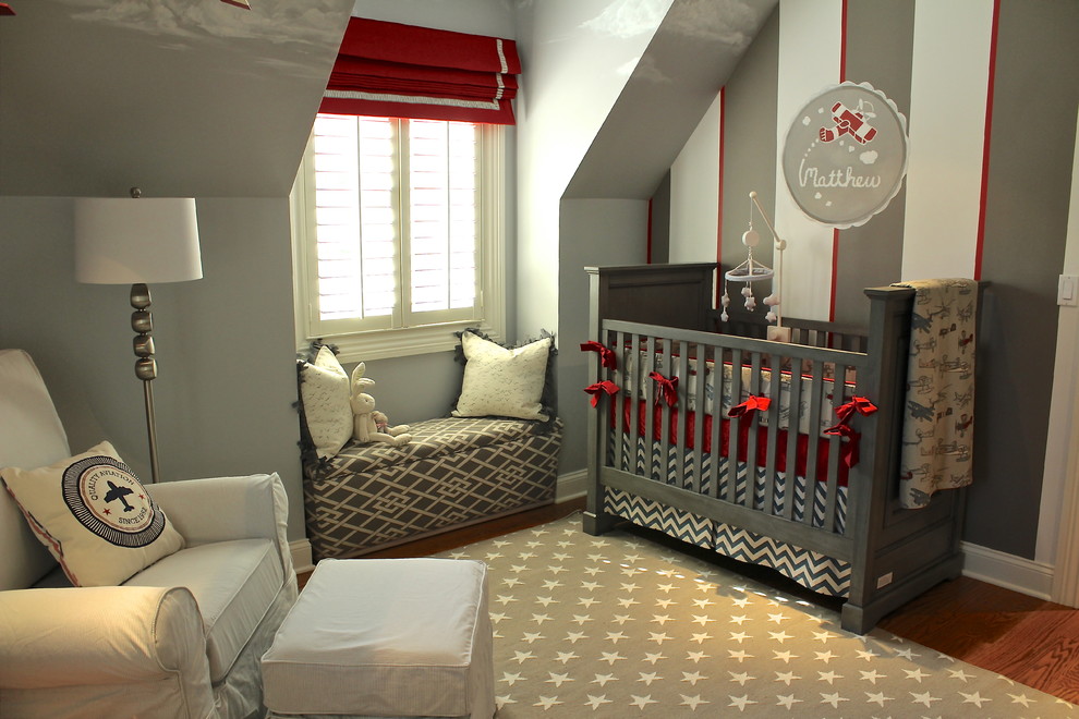 Nursery - small transitional boy medium tone wood floor nursery idea in Chicago with multicolored walls