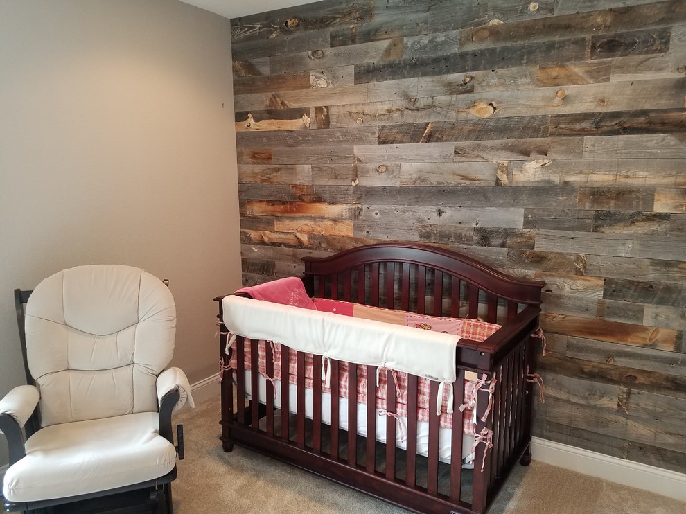 This is an example of a medium sized contemporary nursery in Denver with brown walls, carpet and beige floors.