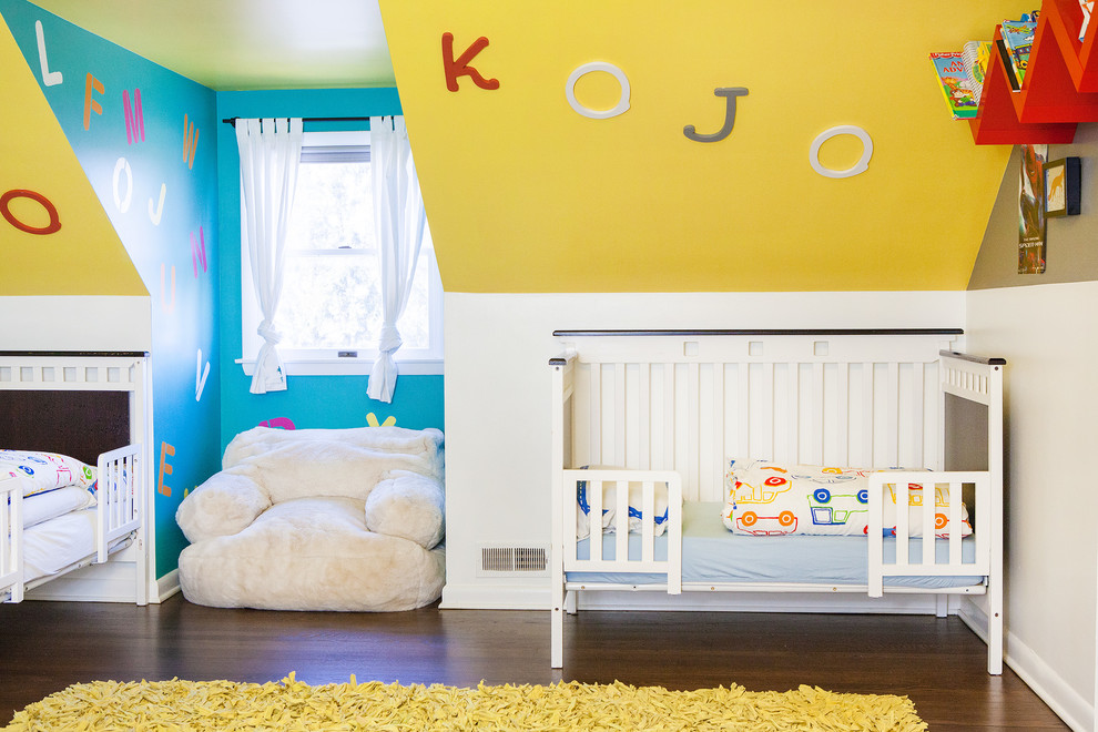 Neutrales Eklektisches Babyzimmer mit gelber Wandfarbe, dunklem Holzboden und braunem Boden in Kolumbus