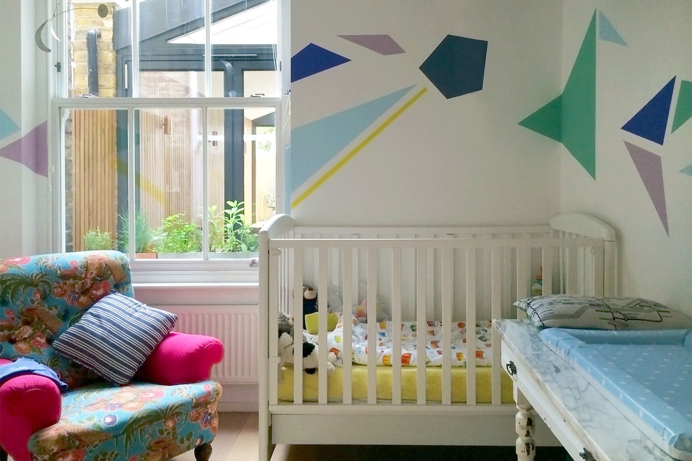 Inspiration for a small contemporary gender-neutral nursery remodel in London with multicolored walls