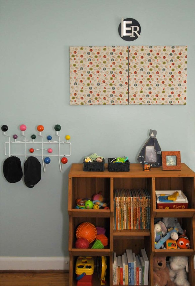 This is an example of a medium sized classic gender neutral nursery in Philadelphia with blue walls and light hardwood flooring.