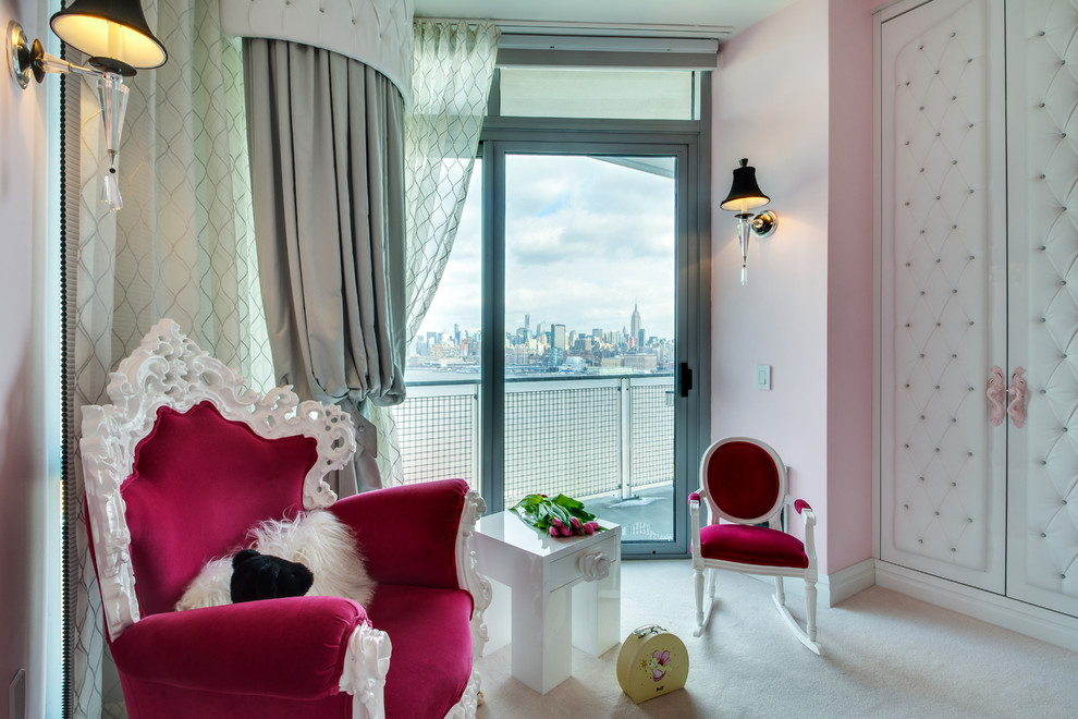 Large traditional nursery for girls in New York with pink walls and carpet.