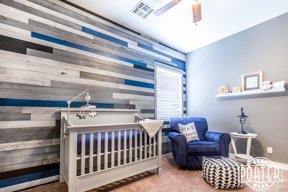 Immagine di una cameretta per neonato design di medie dimensioni con pareti blu e moquette