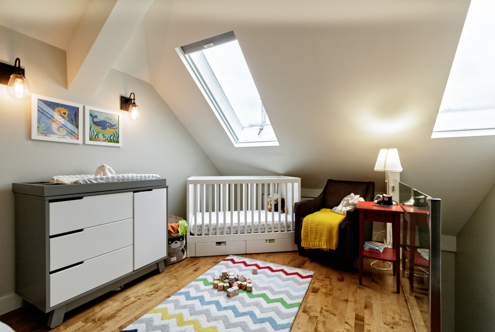 Mid-sized transitional gender-neutral medium tone wood floor and brown floor nursery photo in Vancouver with gray walls