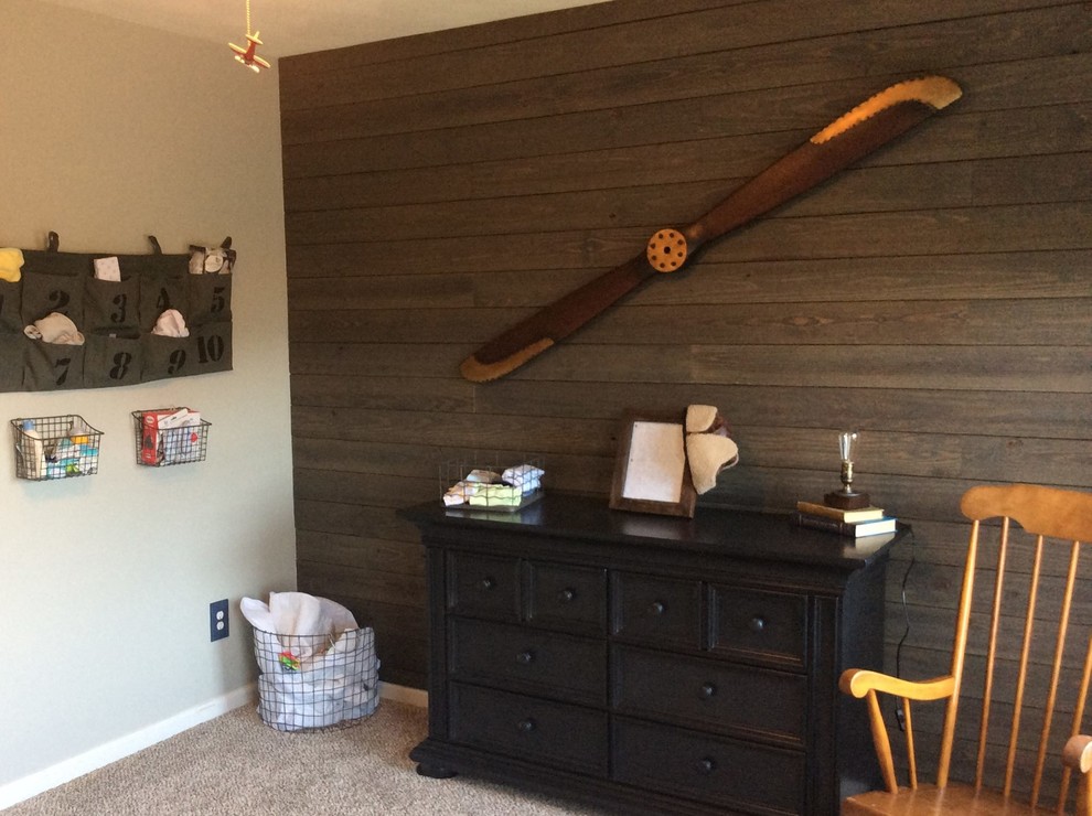Mid-sized arts and crafts boy carpeted and beige floor nursery photo in Other with brown walls