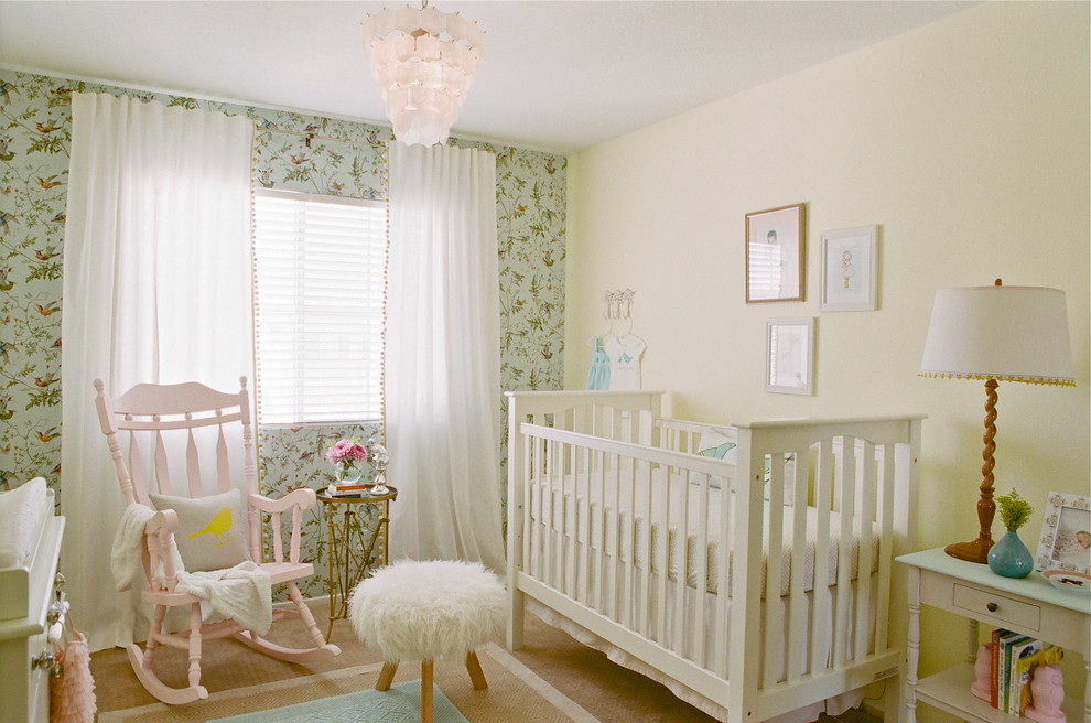 Medium sized traditional nursery for girls in Los Angeles with yellow walls and carpet.