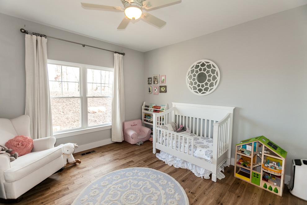 This is an example of a farmhouse nursery in St Louis with beige walls.