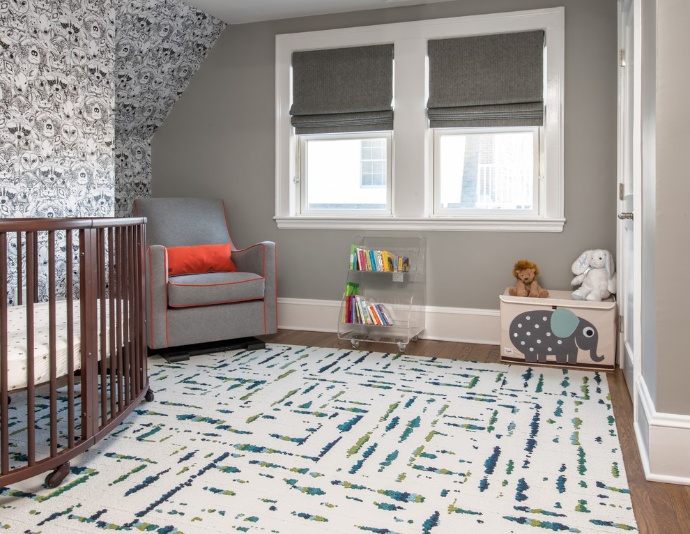 This is an example of a medium sized classic gender neutral nursery in Boston with grey walls, medium hardwood flooring and brown floors.
