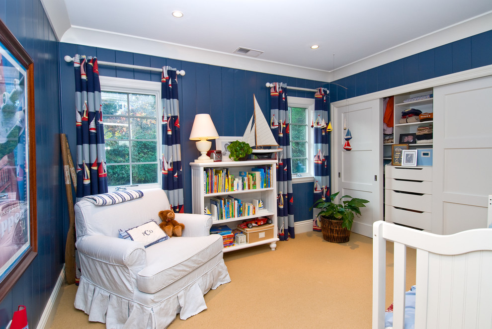Inspiration for a medium sized beach style nursery for boys in San Francisco with blue walls, carpet and beige floors.