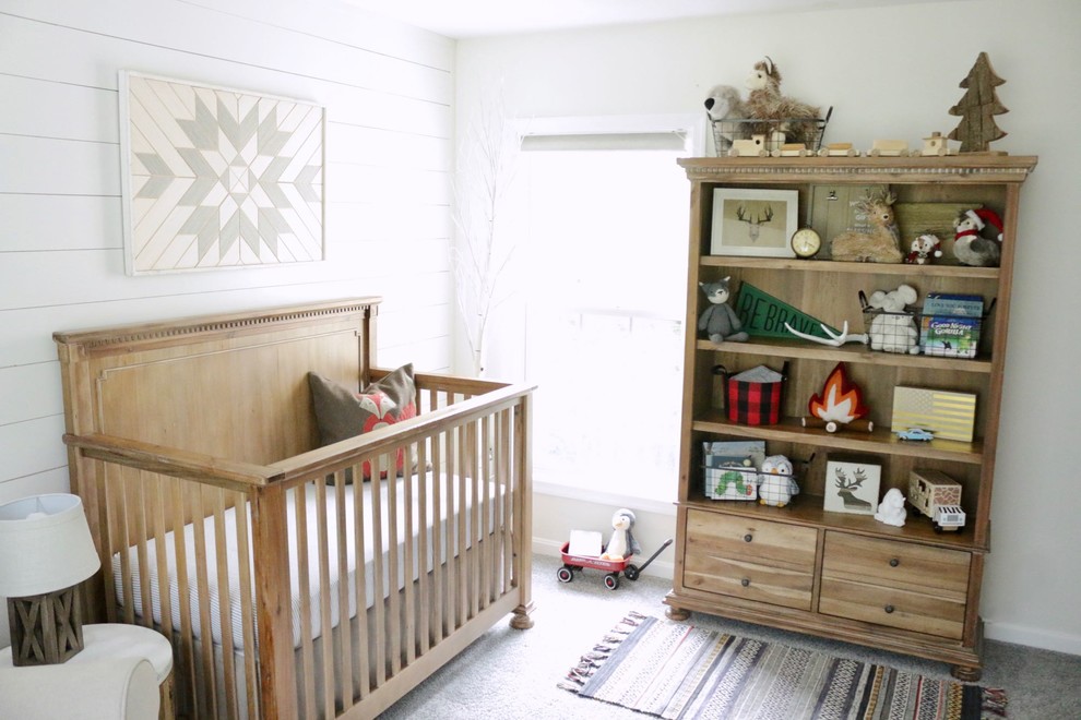 This is an example of a medium sized rustic nursery for boys in Bridgeport with white walls, carpet and grey floors.