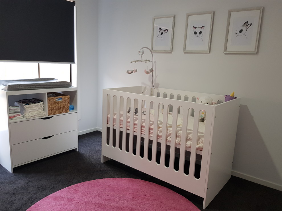 Nursery - mid-sized contemporary girl carpeted nursery idea in Melbourne with white walls