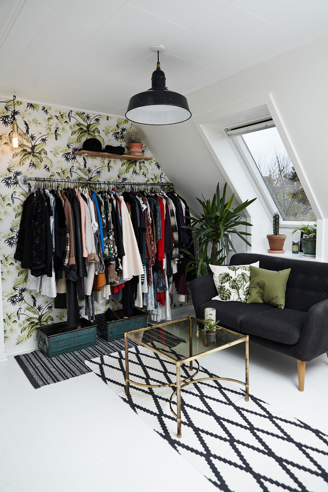 Inspiration for a small contemporary dressing room for women in Wiltshire with open cabinets, painted wood flooring, white floors and a feature wall.