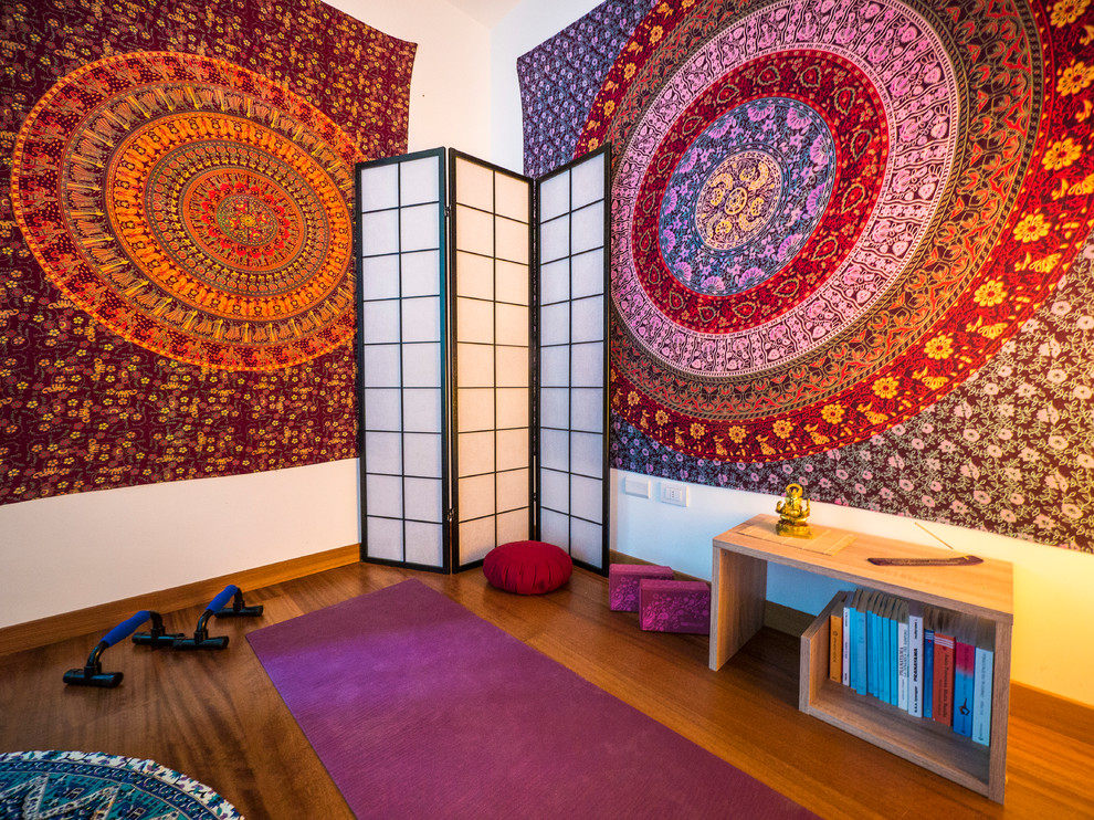 Mid-sized eclectic medium tone wood floor home yoga studio photo in Milan with white walls