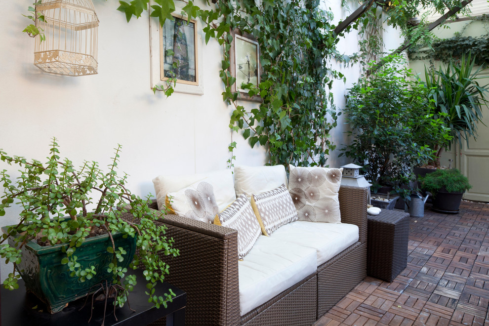 Example of a cottage chic brick patio design in Milan