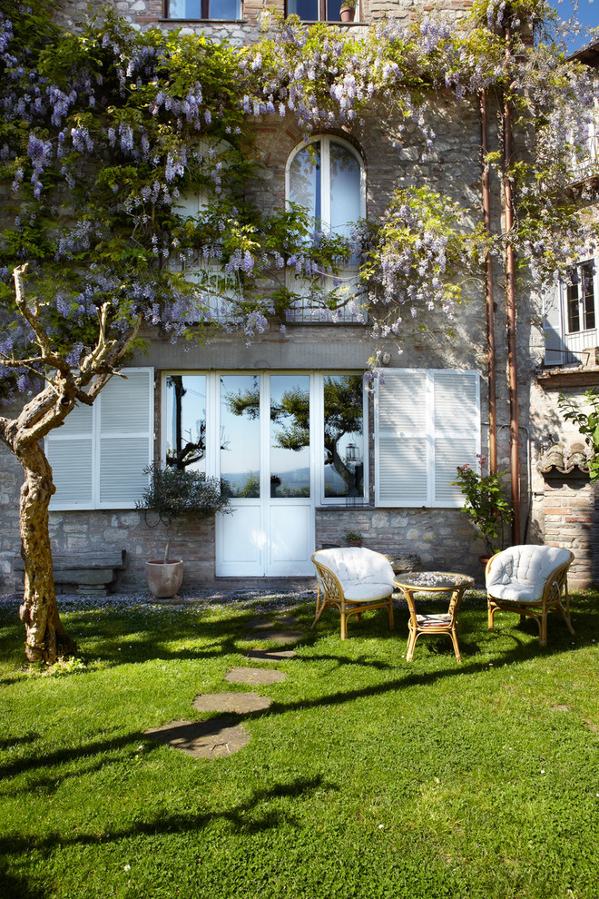 Esempio di un patio o portico mediterraneo dietro casa con nessuna copertura