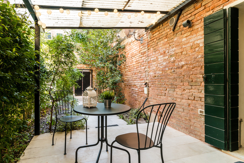 Inspiration for a mediterranean patio in Venice with a pergola.