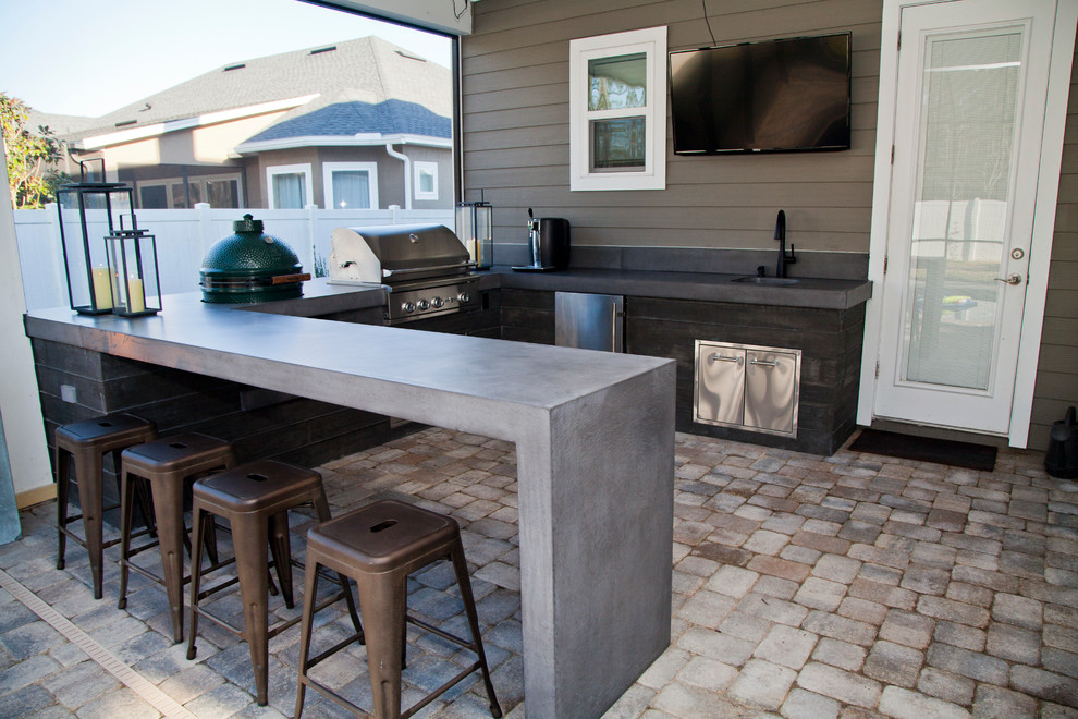 Inspiration for a mid-sized modern backyard brick patio kitchen remodel in Jacksonville