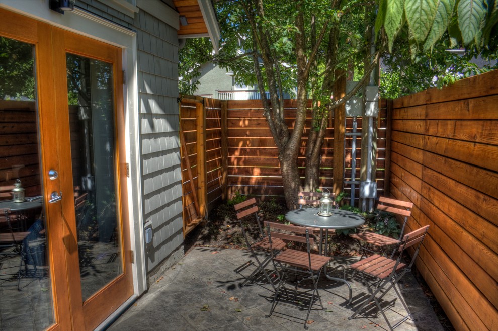 Inspiration for a classic back patio in Vancouver with concrete slabs.