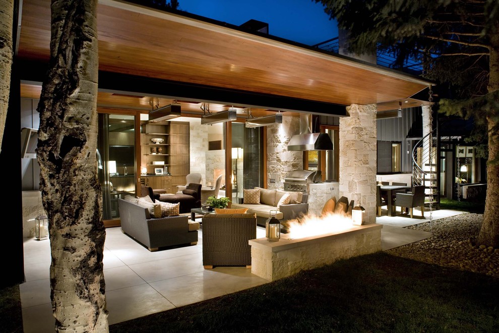 Patio - contemporary patio idea in Denver with a fire pit and a roof extension