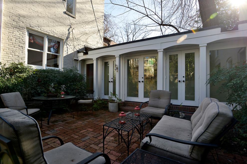 Ispirazione per un piccolo patio o portico tradizionale in cortile con pavimentazioni in mattoni
