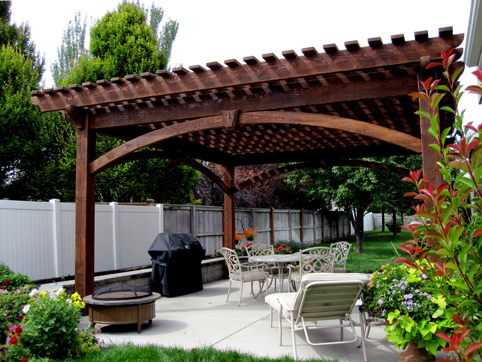 Patio - large traditional backyard patio idea in Salt Lake City with a pergola
