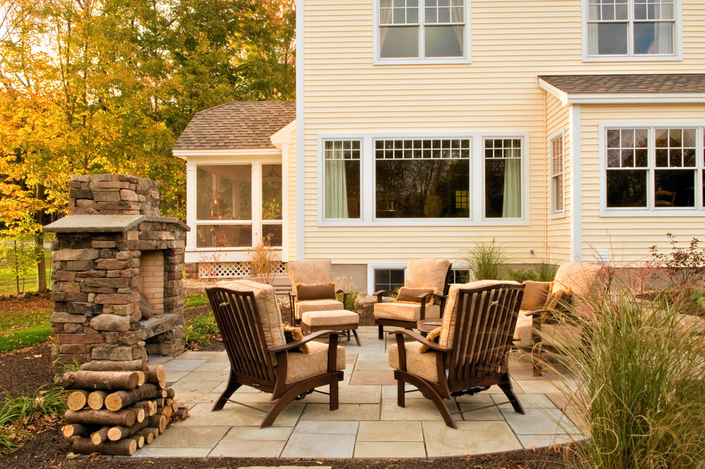 Example of a classic patio design in New York with a fire pit