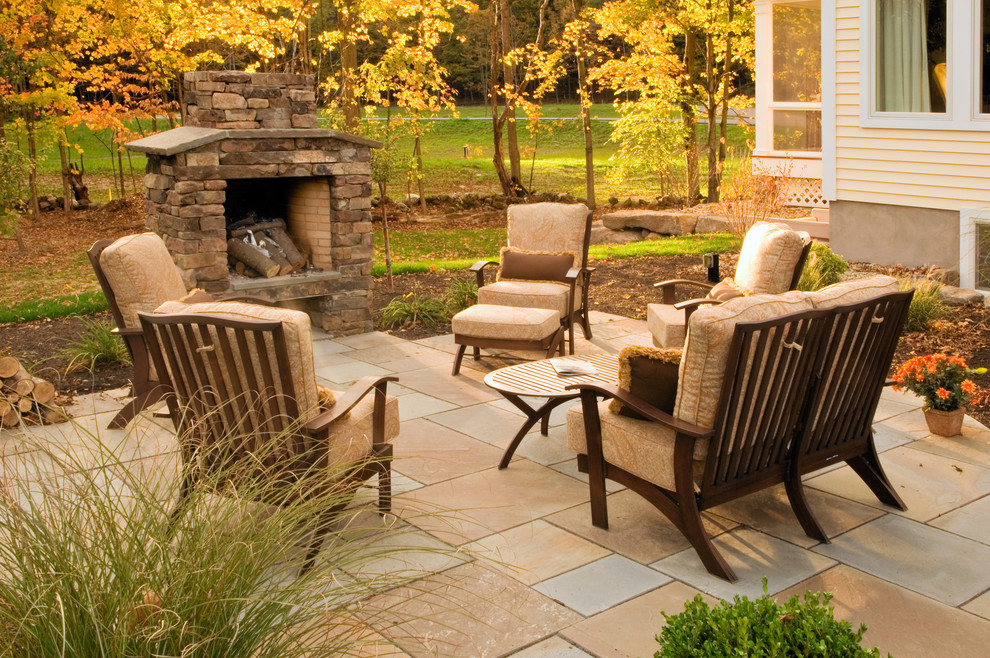 Inspiration for a timeless patio remodel in New York with a fire pit