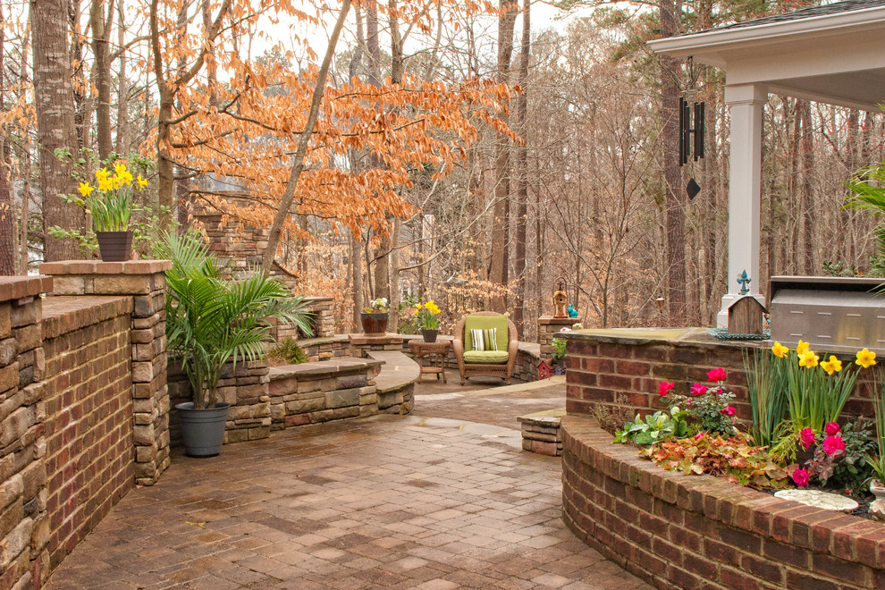 Patio - mid-sized transitional backyard concrete paver patio idea in Raleigh with a fire pit and a roof extension