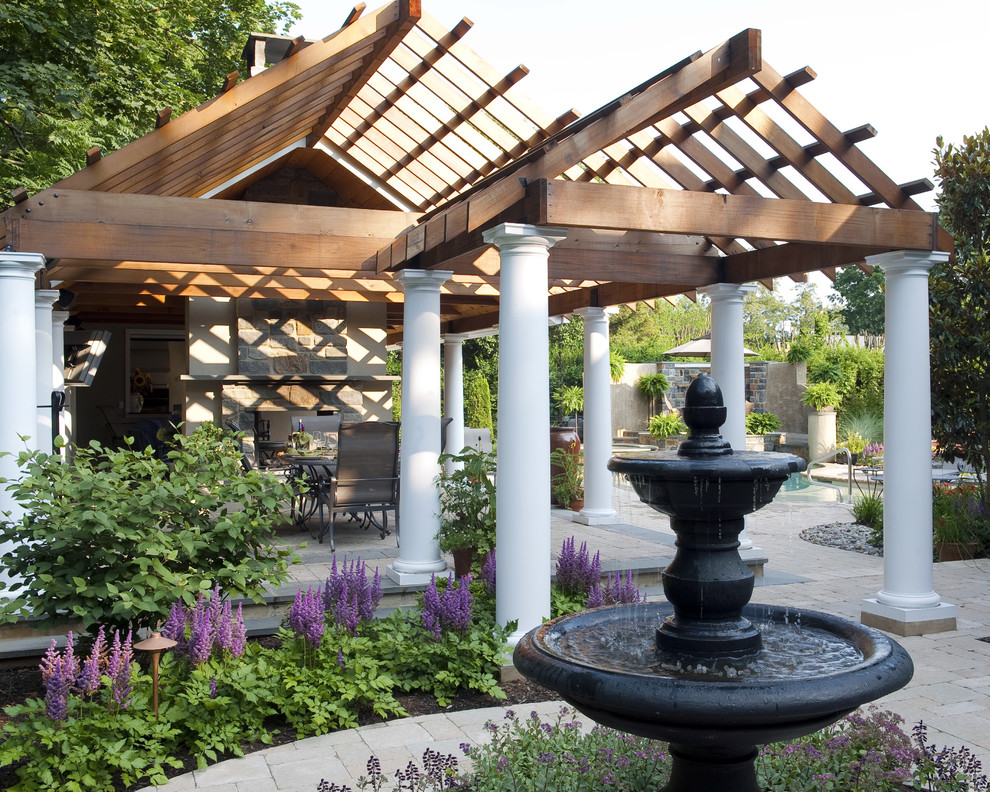 Design ideas for a traditional back patio in Other with a gazebo and a water feature.
