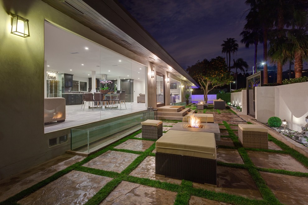 Inspiration for a contemporary patio remodel in Los Angeles with a fire pit and no cover