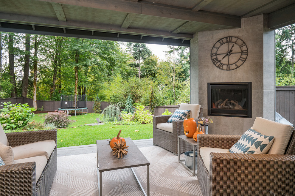 Transitional backyard patio photo in Seattle with a fireplace