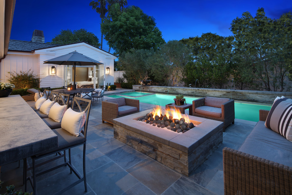 This is an example of a classic patio in Orange County with a fire feature and no cover.