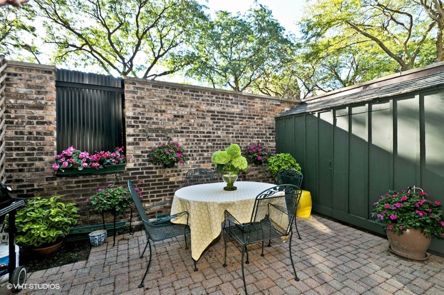 Foto di un patio o portico tradizionale di medie dimensioni e davanti casa con un giardino in vaso, pavimentazioni in mattoni e nessuna copertura
