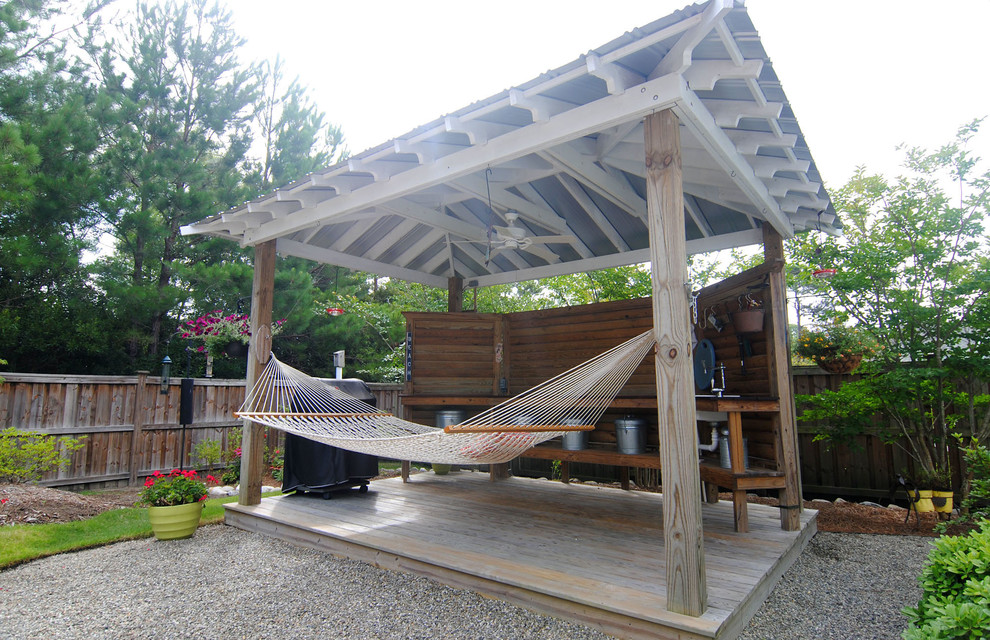 This is an example of a large world-inspired back patio in Other with an outdoor shower, decking and a pergola.