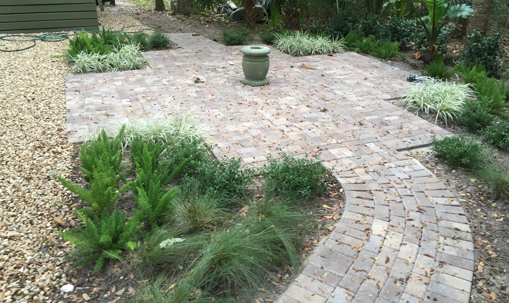 Small arts and crafts side yard concrete paver patio fountain photo in Miami with no cover
